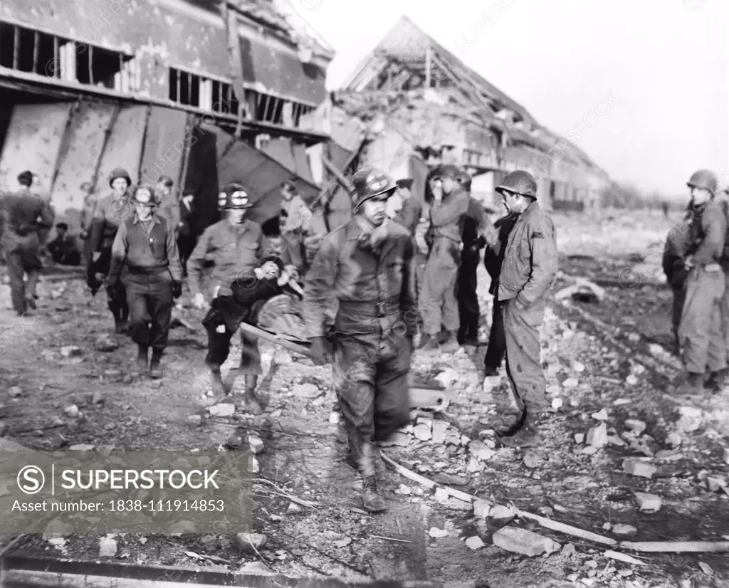 Polish Laborer being carried to Ambulance by American Medics at German Slave Labor Camp at time of Liberation by U.S. Army, Nordhausen, Germany, photograph by Roberts for U.S. Army Signal Corps, April 1945