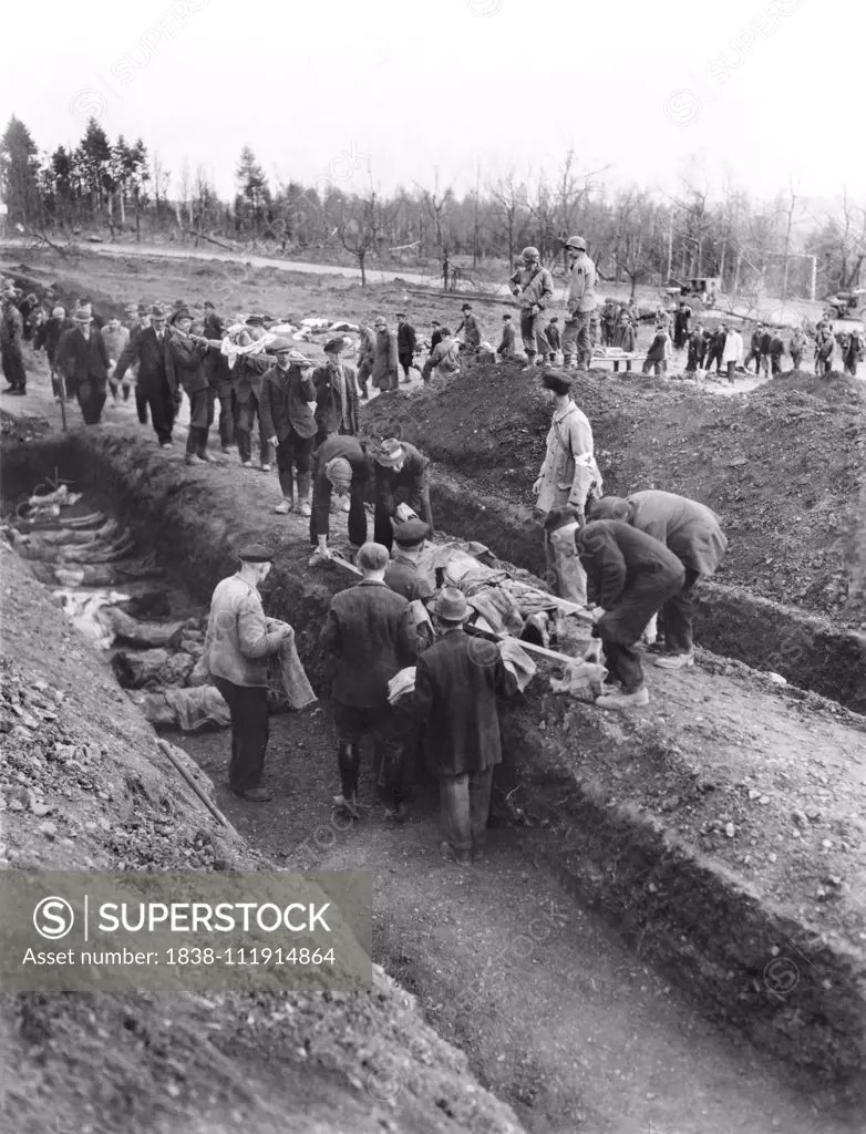 German People digging Graves for Mass Burial of Dead Prisoners at German Slave Labor Camp at time of Liberation by U.S. Army, Nordhausen, Germany, photograph by Driza for U.S. Army Signal Corps, April 1945