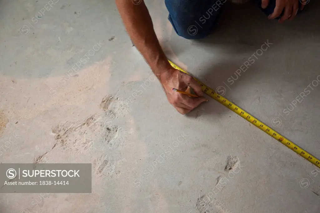 Contractor Measuring and Marking Floor