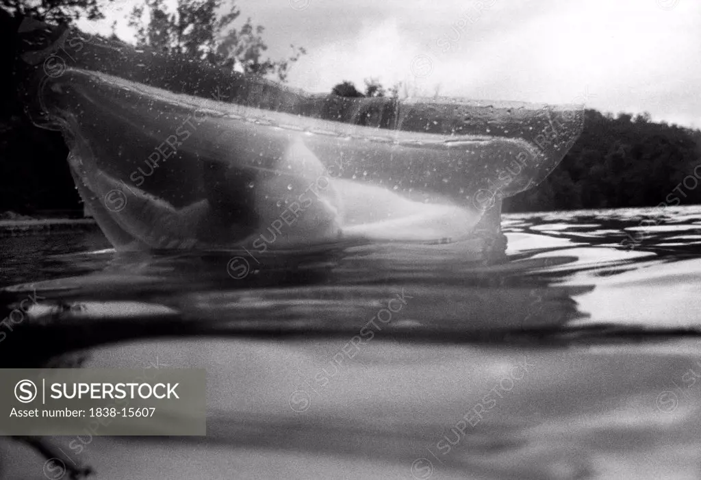 Girl Floating on Inflatible Raft in Lake