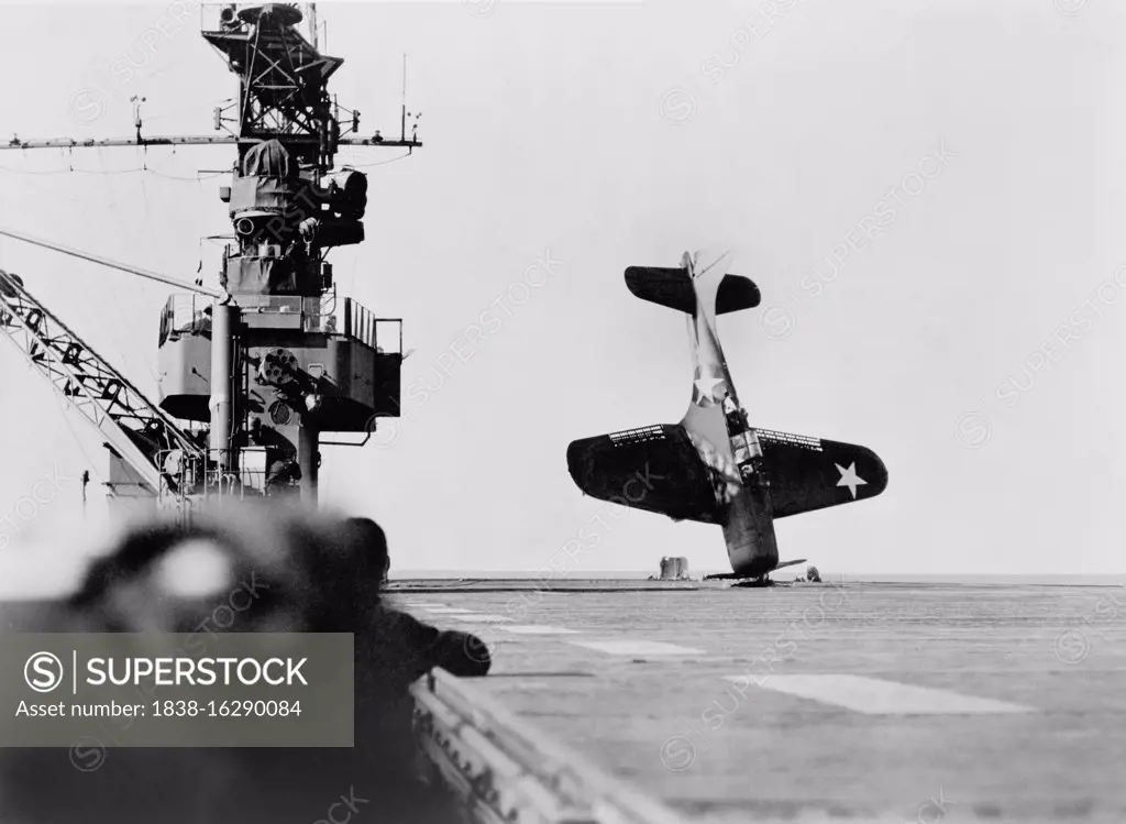 Douglas SBD "Dauntless" Dive Bomber balanced on Nose after crash landing on Carrier Flight Deck, Pacific Ocean, Official U.S. Navy photo, June 21, 1943