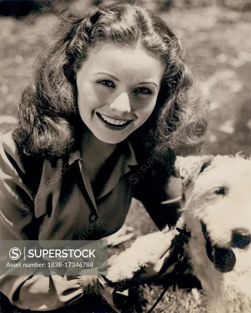 Actress Jeanne Crain (1925-2003), Head and Shoulders Publicity Portrait with pet dog, mid-1940's