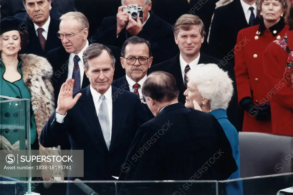 Chief Justice William Rehnquist administering Oath of Office to George Bush on west front of U.S. Capitol, with Dan Quayle and Barbara Bush looking on, Architect of the Capitol Collection, January 20, 1989