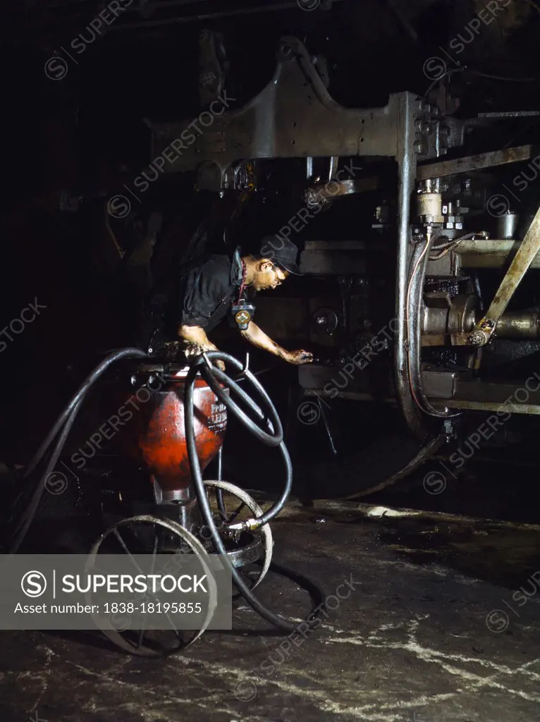 Thomas Madrigal greasing Locomotive Train in Roundhouse, Rock Island Railroad, Blue Island, Illinois, USA, Jack Delano, U.S. Office of War Information, April 1943