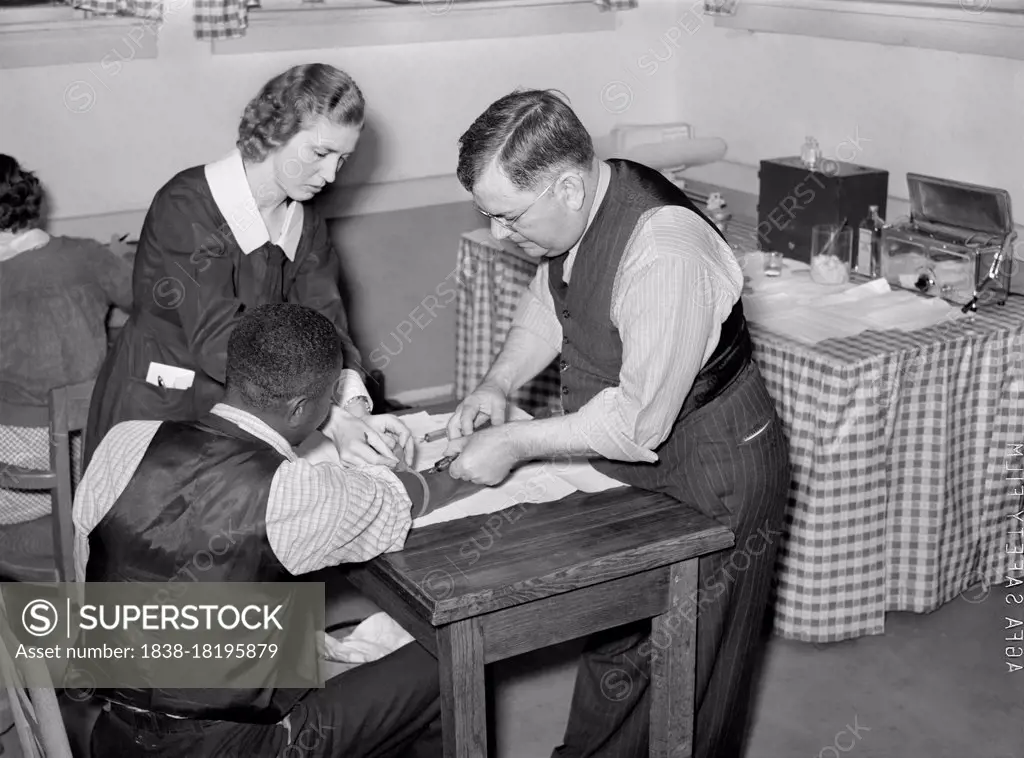 Miss Teal, Nurse, and Doctor W.R. Stanley giving treatment in Venereal Disease Clinic. Enterprise, Alabama, USA, Marion Post Wolcott, U.S. Farm Security Administration, April 1939