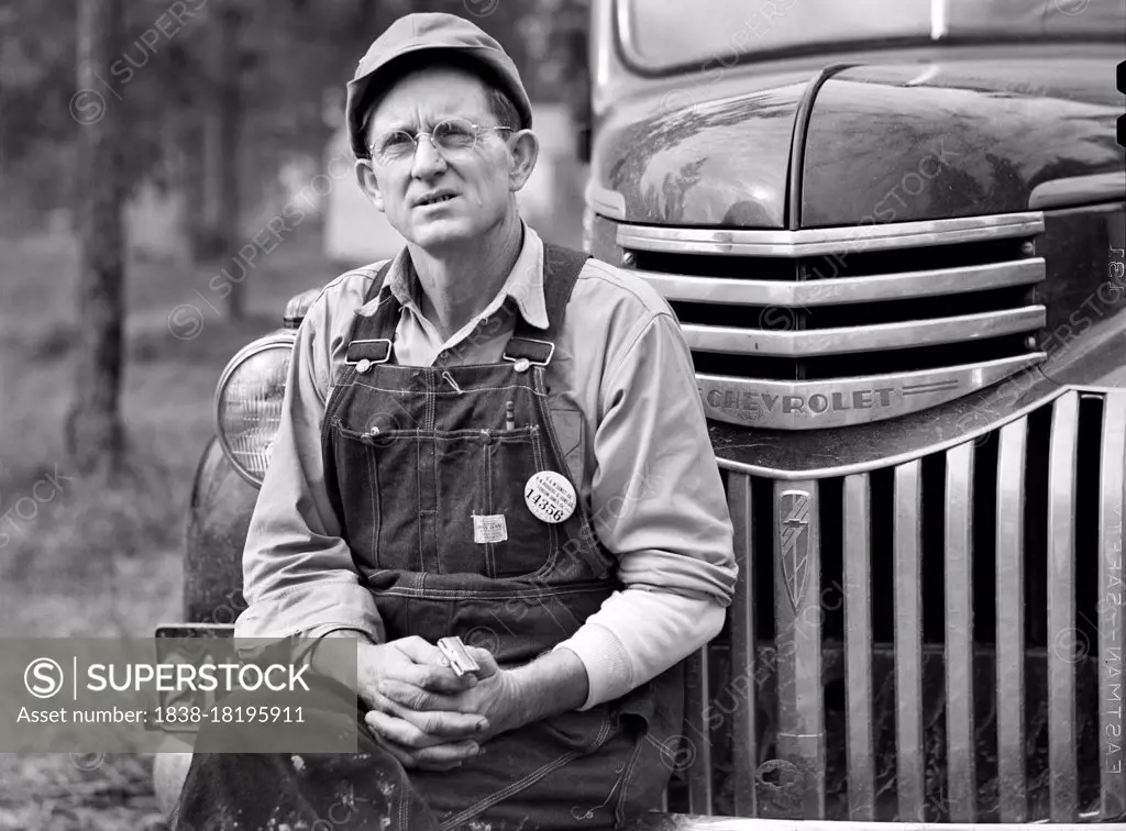 Construction Worker sitting on Car before leaving for Evening Shift, Camp Livingston, Alexandria, Louisiana, USA, Marion Post Wolcott, U.S. Farm Security Administration, December 1940