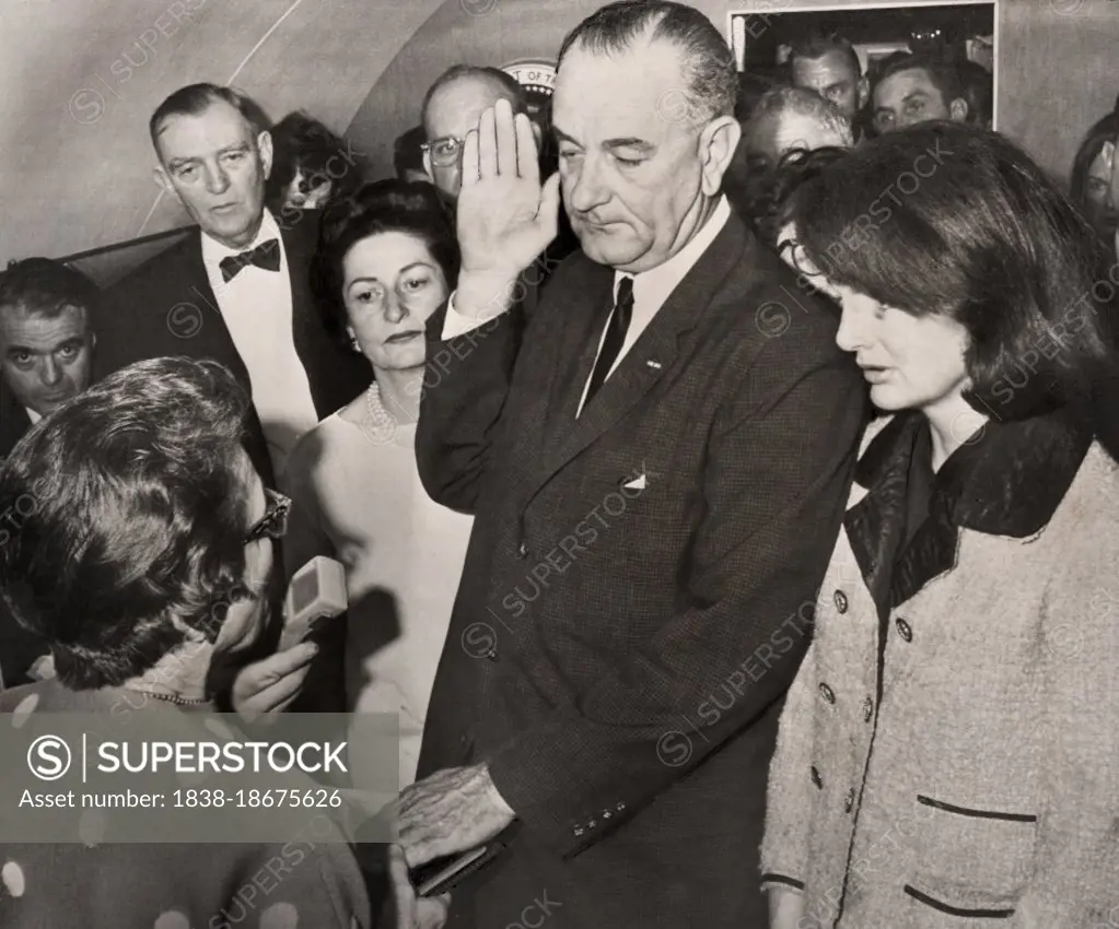 Lyndon Johnson being sworn in as U.S. President by Judge Sarah Hughes aboard Air Force One after assassination of U.S. President John F. Kennedy, First Lady Claudia "Lady Bird" Johnson and former First Lady Jacqueline Kennedy look on, Love Field Airport, Dallas, Texas, USA, Cecil W. Stoughton, November 22, 1963