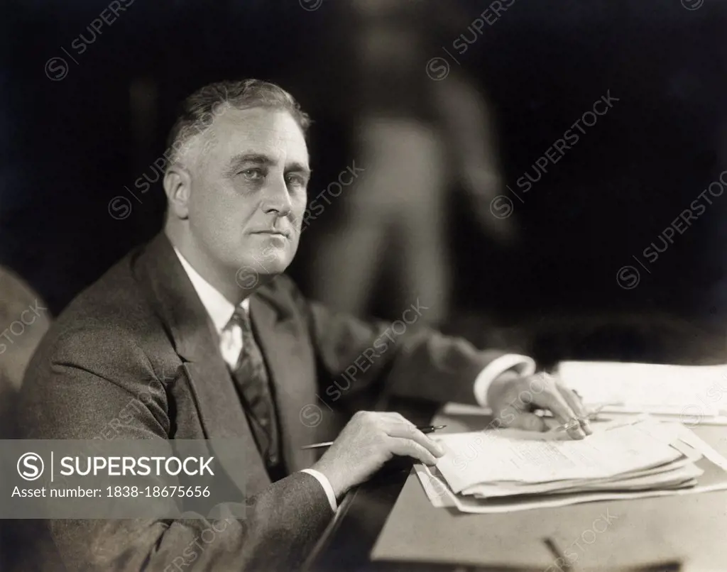 Franklin Roosevelt (1882-1945), 32nd U.S. President, head and shoulders seated portrait at desk, Washington, DC, USA, Harris & Ewing, 1933