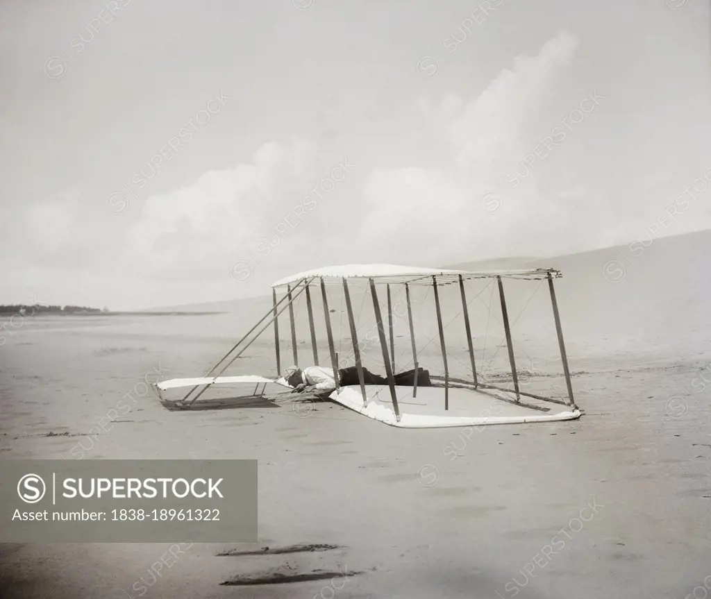 Wilbur Wright in prone position on glider just after landing, Kitty Hawk, North Carolina, USA, Wilber Wright, Orville Wright, 1901