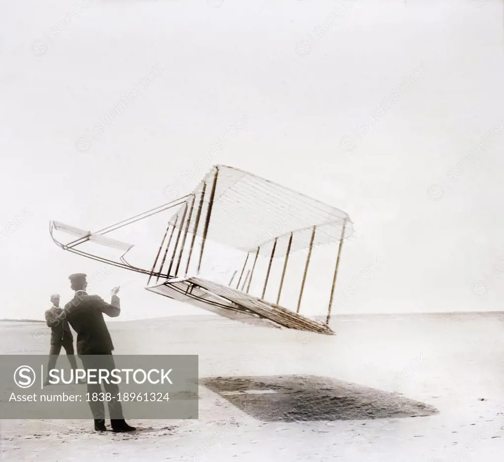 Side view of glider flying as kite near ground, Wilbur at left, Orville at right, Kitty Hawk, North Carolina, USA, Wilber Wright, Orville Wright, 1901