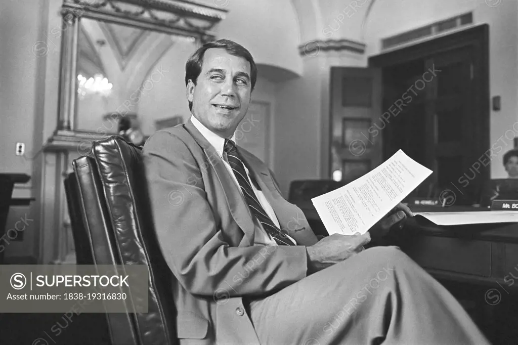 U.S. Congressman from Ohio John Boehner, seated at desk, holding a paper, Washington, D.C., USA, Laura Patterson, Roll Call Photograph Collection, May 1993 