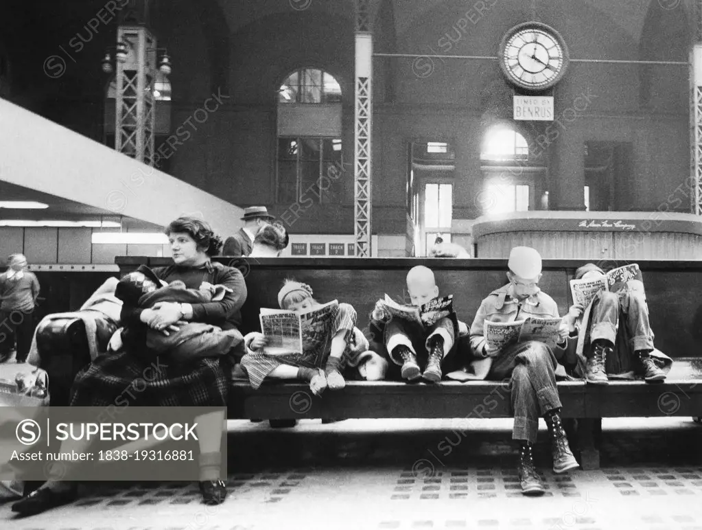 Woman and children seated on bench of train station concourse, Pennsylvania Station, New York City, New York, USA, Angelo Rizzuto, Anthony Angel Collection, April 1959