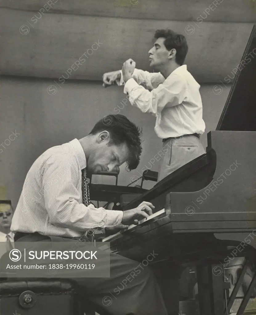 Conductor Leonard Bernstein rehearsing the New York Philharmonic with Piano soloist William Kapell, Lewisohn Stadium, New York City, New York, USA, Unidentified Artist, June 1947 