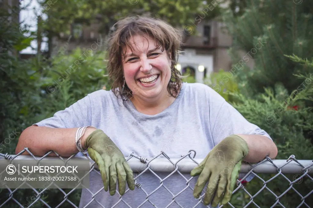 Smiling Gardener Leaning on Fence