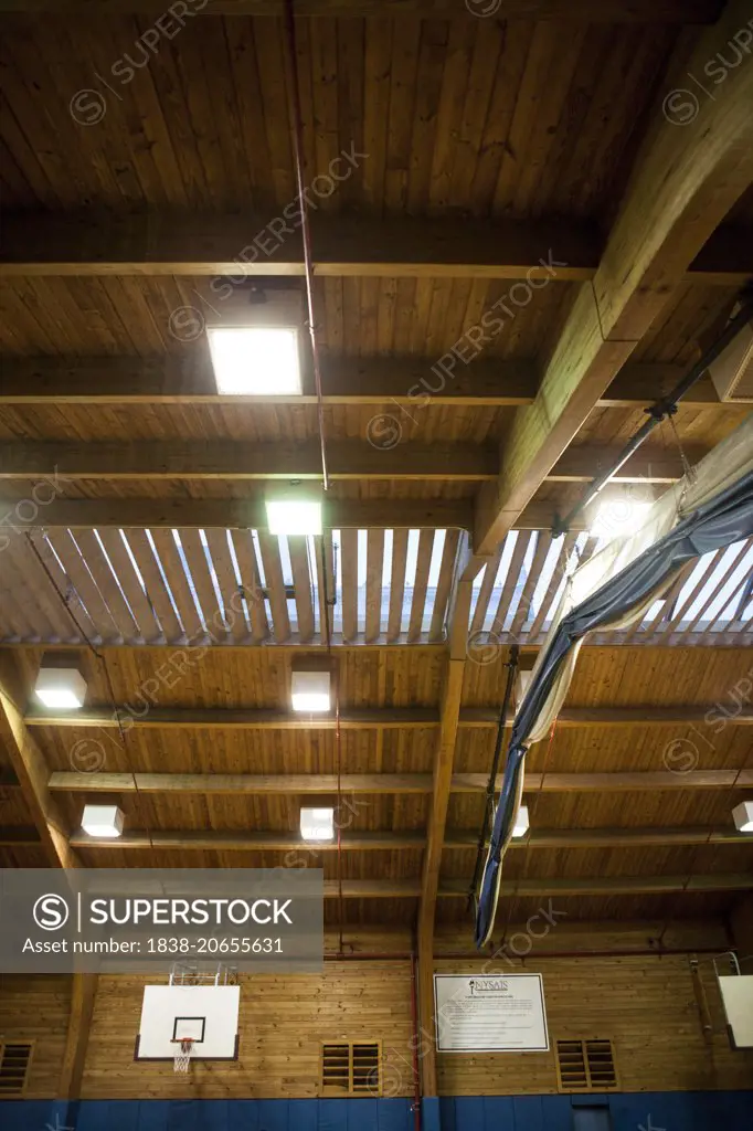 Basketball Hoop and Arched Ceiling in Gymnasium