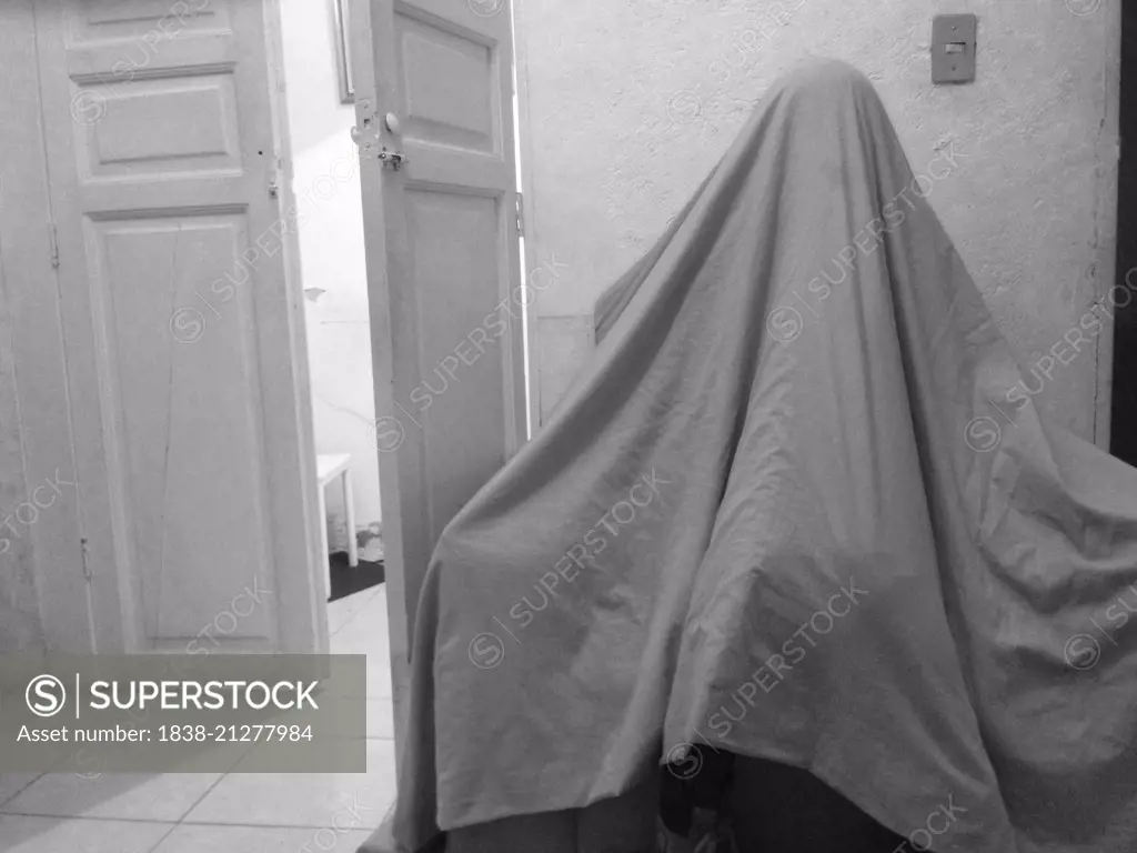 Girl Under Sheet Looking like Ghost