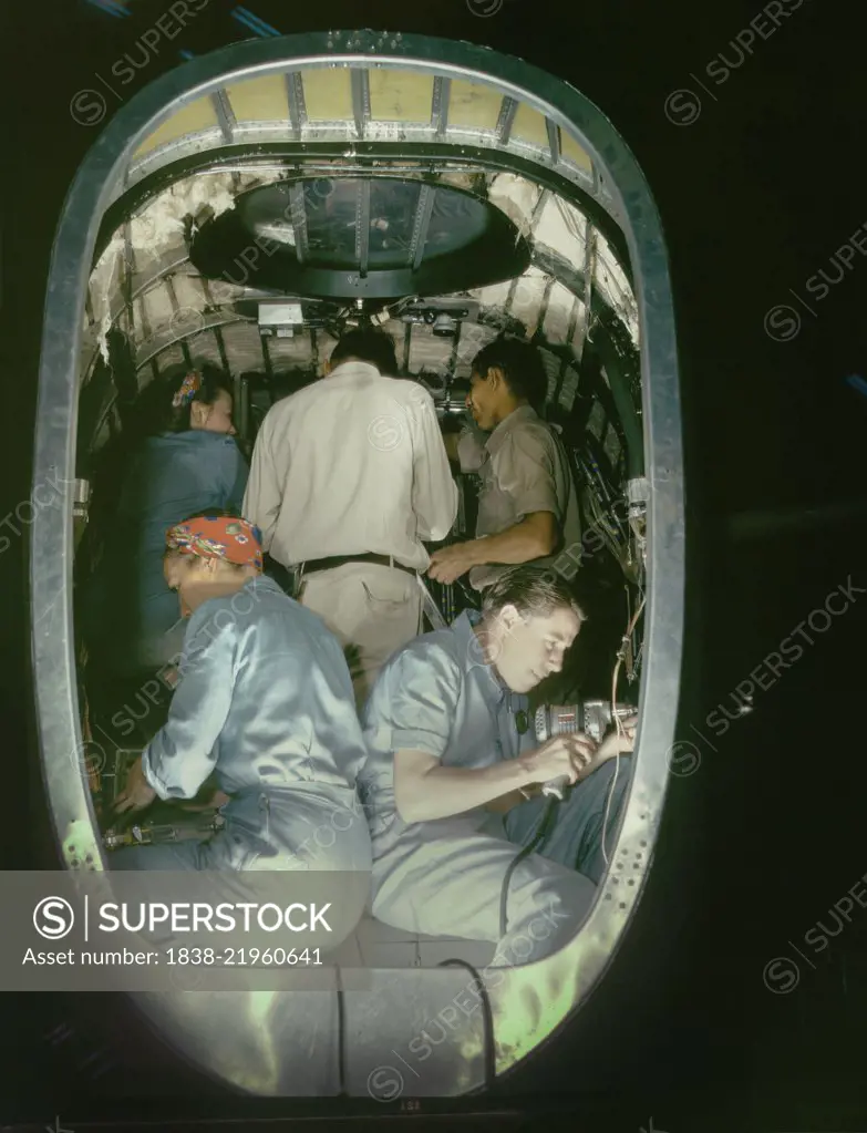 Group of Men and Women Working inside Fuselage of Liberator Bomber, Consolidated Aircraft Corp., Fort Worth, Texas, USA, Howard R. Hollem for Office of War Information, October 1942