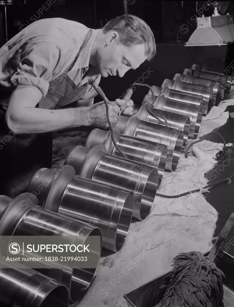 Worker Inspecting and Etching Cylinder Barrels for Airplane Engines at Manufacturing Plant, Pratt & Whitney, East Hartford, Connecticut, USA, Andreas Feininger for Office of War Information, June 1942