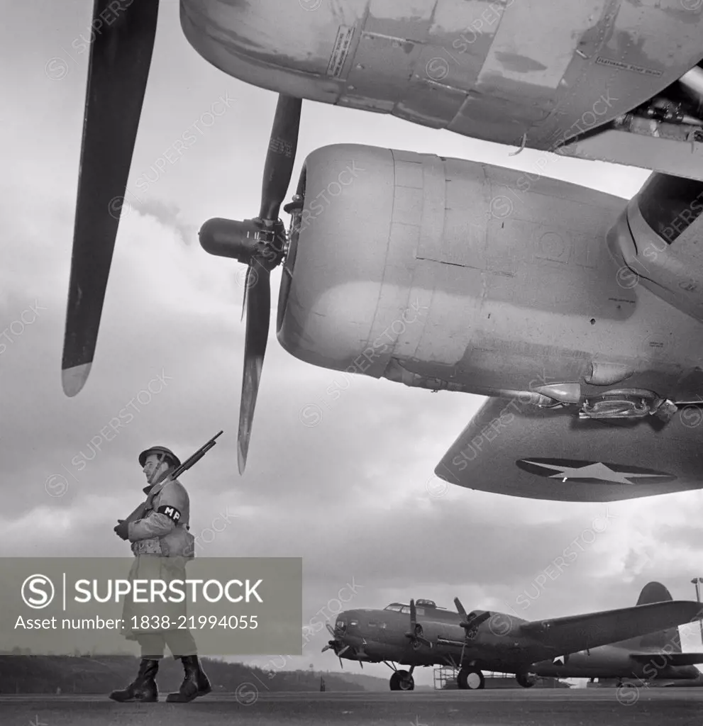 Army Sentry Guarding new B-17F (Flying Fortress) Bombers at Airfield of Boeing Plant, Seattle, Washington, USA, Andreas Feininger for Office of War Information, December 1942