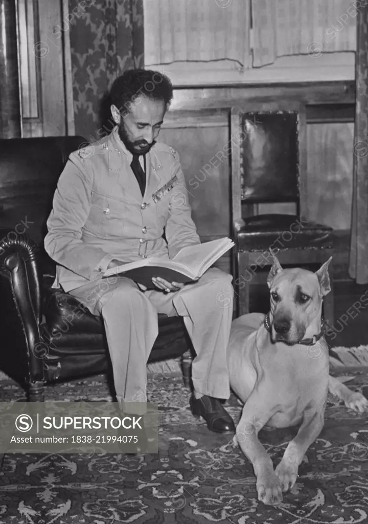 Haile Selassie (1892-1975), Emperor of Ethiopia, Portrait Reviewing Report alongside his Pet Dog, Bull, Upon his Return to Addis Ababa, Ethiopia after Allied Defeat of Italian Fascist Occupation Forces, Office of War Information, 1941