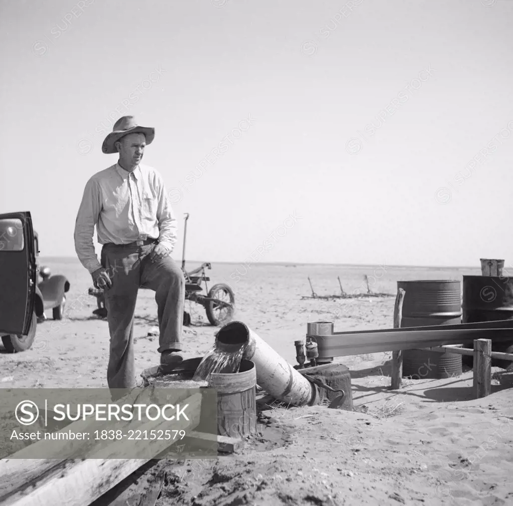 Farmer Pumping Water from Well to Parched Fields during Drought, Cimarron County, Oklahoma, USA, Arthur Rothstein, Farm Security Administration, April 1936