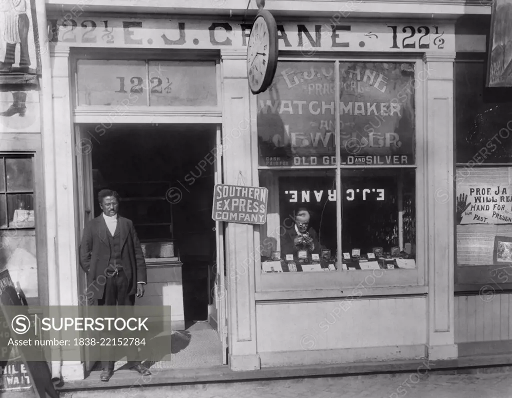 Man Working in Window and Man Standing in Doorway, E.J. Crane Watchmaker and Jewelry Store, Richmond, Virginia, USA, 1900