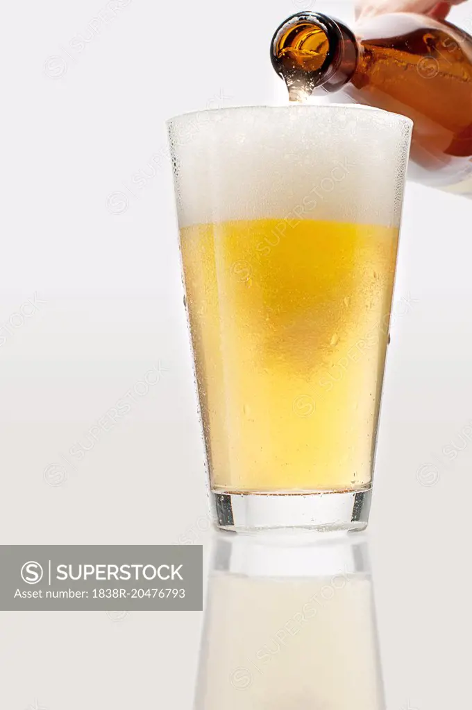 Man Pouring lager Beer into Glass