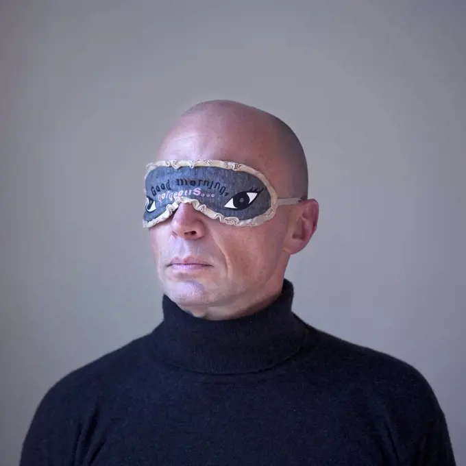 Head and Shoulders Portrait of Man Wearing Eye Mask