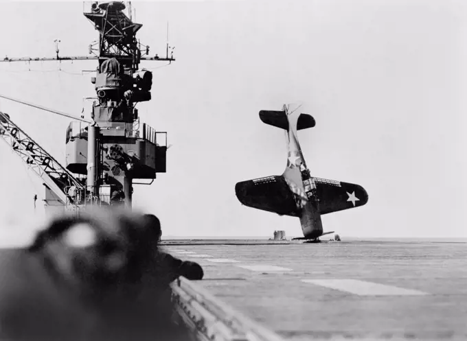 Douglas SBD "Dauntless" Dive Bomber balanced on Nose after crash landing on Carrier Flight Deck, Pacific Ocean, Official U.S. Navy photo, June 21, 1943