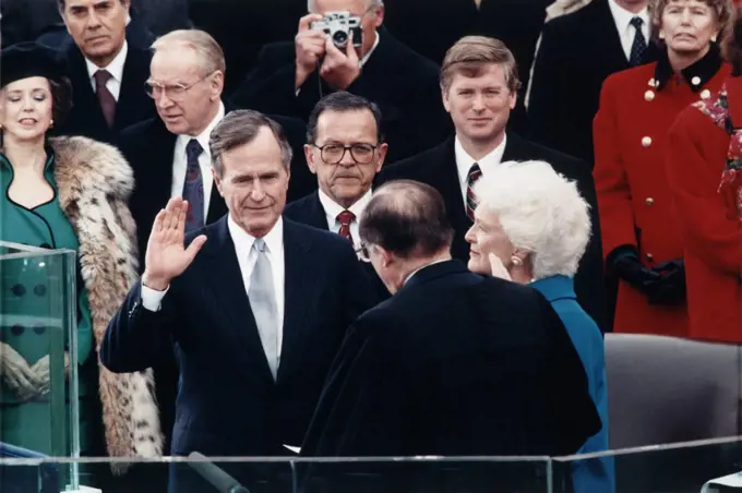Chief Justice William Rehnquist administering Oath of Office to George Bush on west front of U.S. Capitol, with Dan Quayle and Barbara Bush looking on, Architect of the Capitol Collection, January 20, 1989