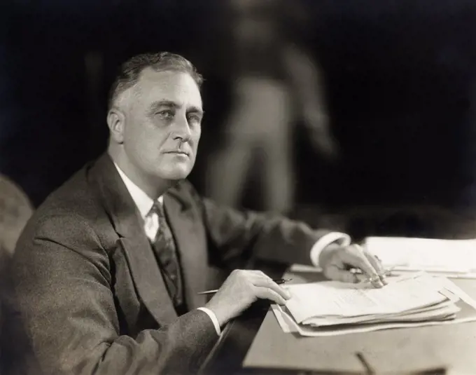 Franklin Roosevelt (1882-1945), 32nd U.S. President, head and shoulders seated portrait at desk, Washington, DC, USA, Harris & Ewing, 1933