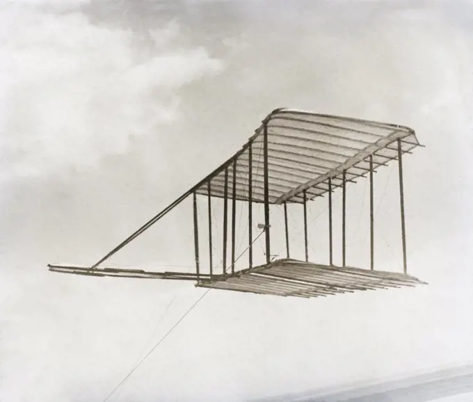 Left side view of glider flying as kite, in level flight, Kitty Hawk, North Carolina, USA, Wilber Wright, Orville Wright, 1900