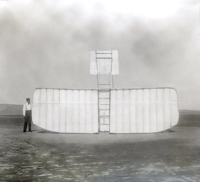 Orville Wright at left wing end of upended glider, Kitty Hawk, North Carolina, USA, Wilber Wright, Orville Wright, 1901