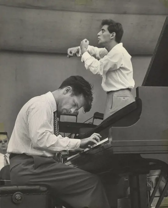 Conductor Leonard Bernstein rehearsing the New York Philharmonic with Piano soloist William Kapell, Lewisohn Stadium, New York City, New York, USA, Unidentified Artist, June 1947 