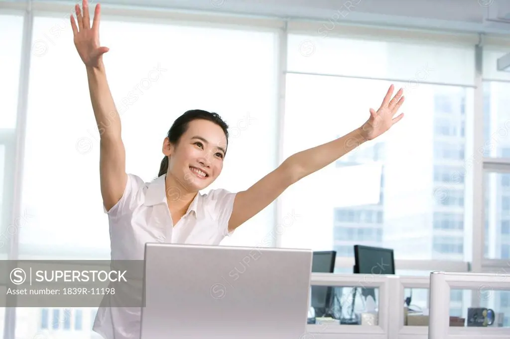 Happy office worker at her desk