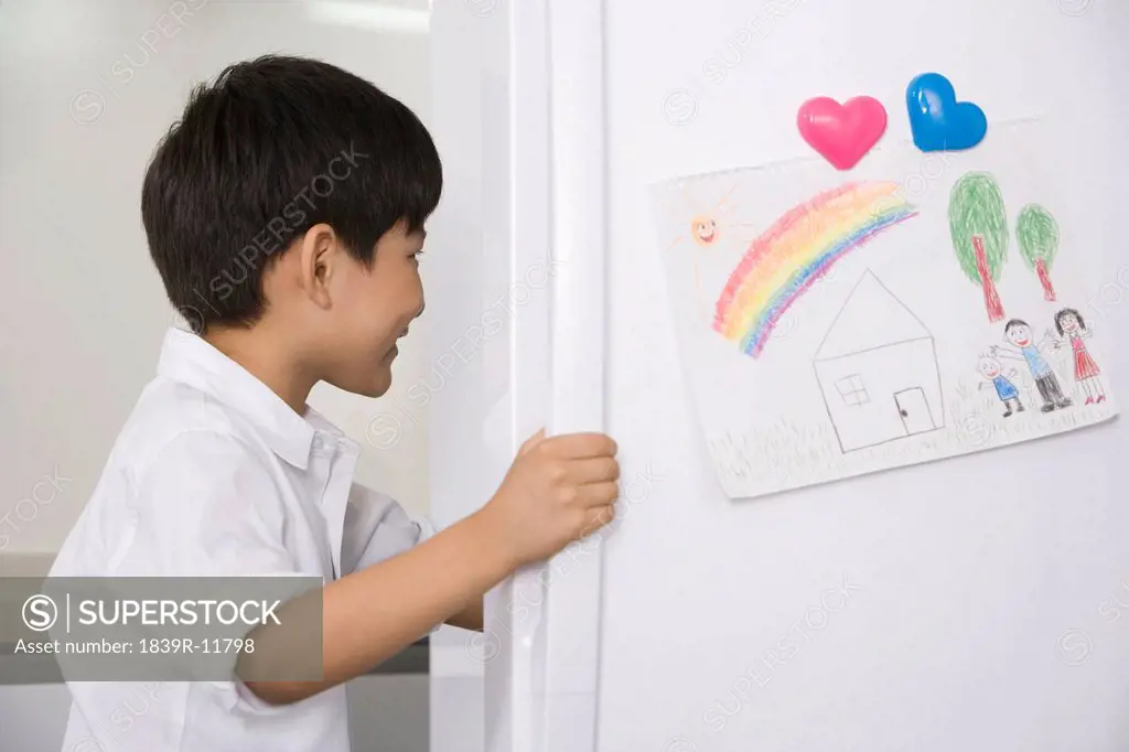 Young boy opening refrigerator