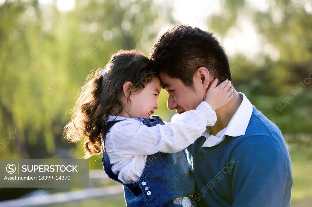 Portrait of father and daughter at the park