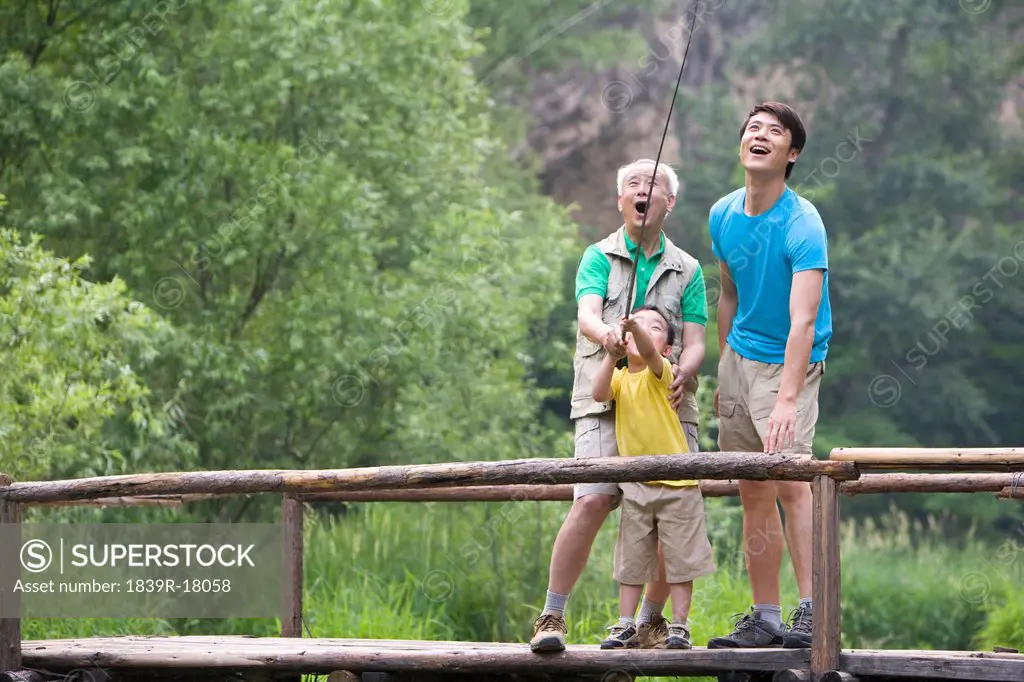 Portrait of three generations fishing