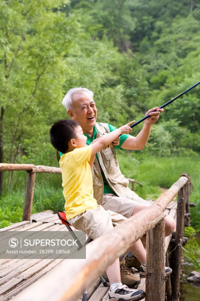 Grandfather and grandson fishing