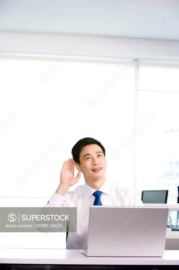 Happy office worker at his desk