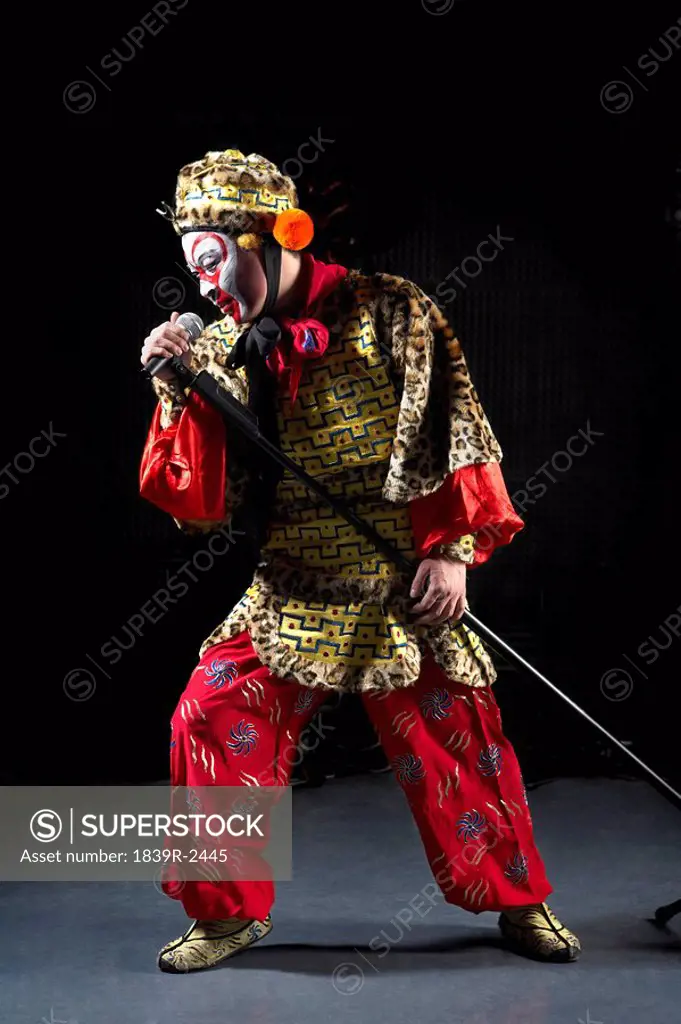 Man In Ceremonial Costume With Microphone