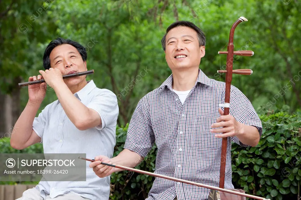 Old men playing Chinese traditional instrument in park