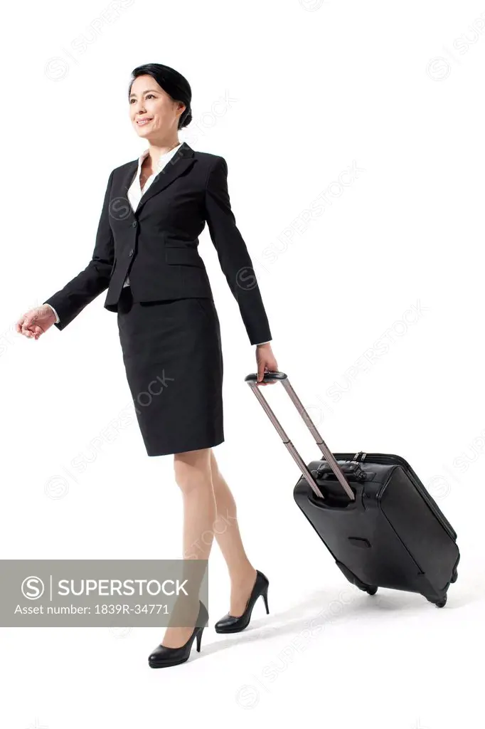 Happy businesswoman with her luggage on a trip