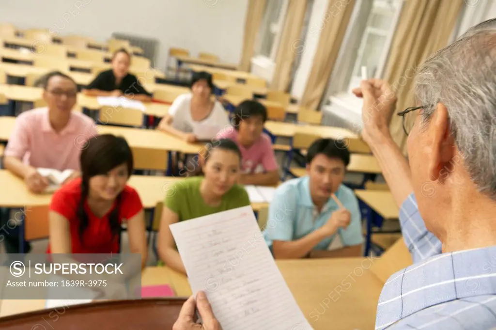 Teacher Lecturing Students In A Class Room