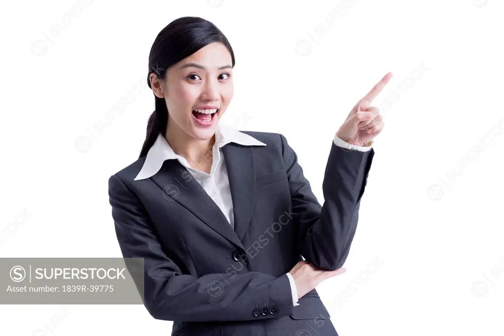 Cheerful businesswoman pointing