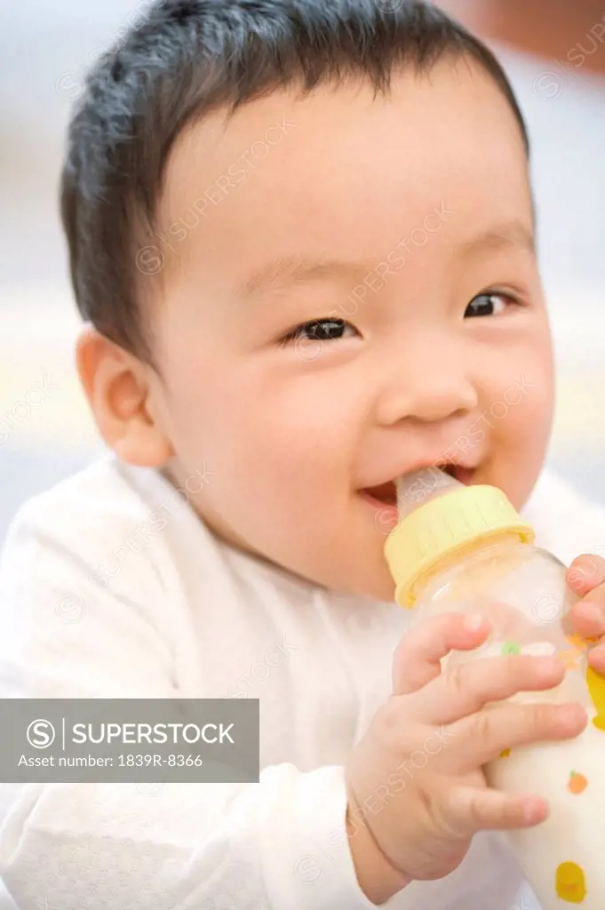 Infant with milk bottle