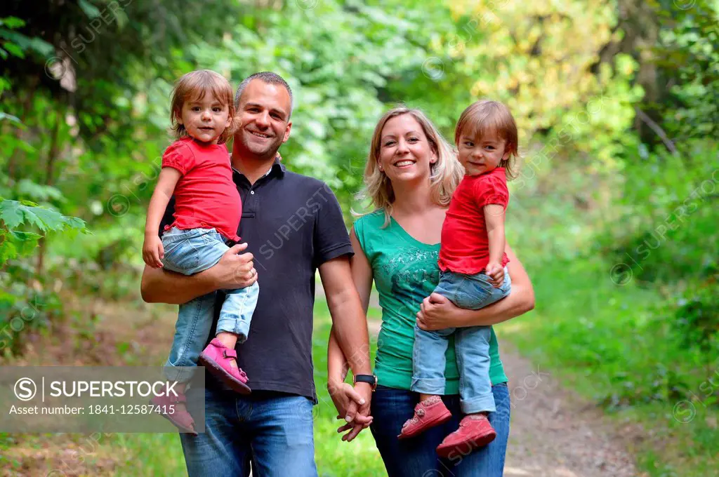 Identical twins with their parents