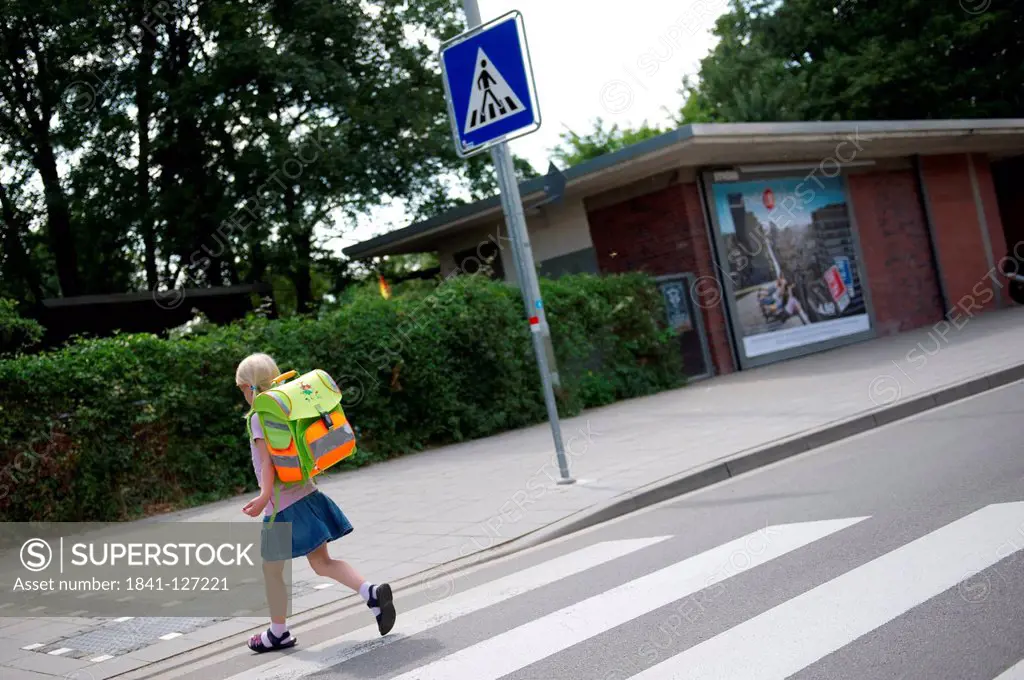 Girl is crossing a road