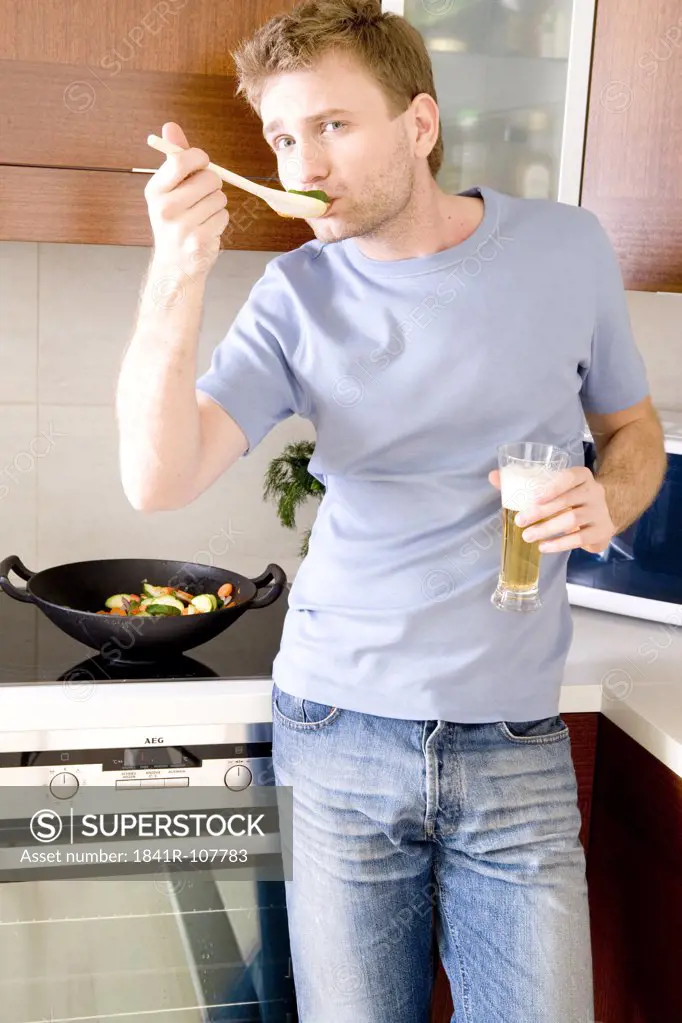 man cooking with beer