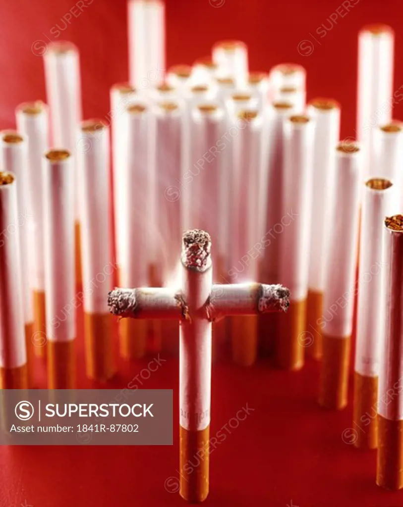 Close-up of cross made by cigarettes